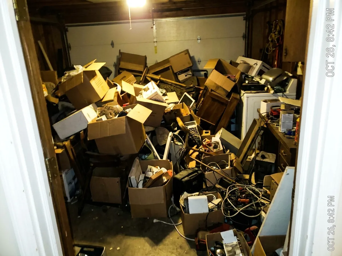 A phone photo of a cluttered garage