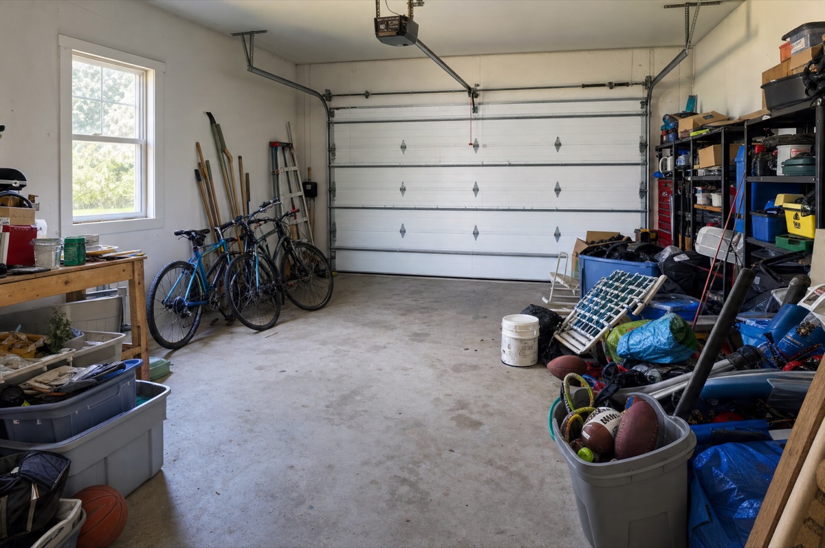 A cluttered Oakland garage before cleanout, packed with boxes and furniture